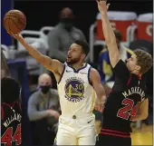  ?? JED JACOBSOHN — THE ASSOCIATED PRESS ?? Warriors guard Steph Curry shoots over Bulls forward Lauri Markkanen, right during the second half on Monday in San Francisco.