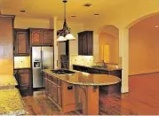  ??  ?? The home’s kitchen has granite countertop­s and stainless steel appliances.