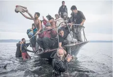  ??  ?? Refugees and migrants arrive near the village of Skala, on the Greek island of Lesbos.