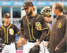  ?? Sue Ogrocki / Associated Press ?? Padres shortstop Fernando Tatis Jr. leaves the field Tuesday because of an issue with his left shoulder.