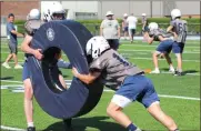  ?? Scott Herpst ?? Gabe Daugherty (left) and Brisyn Oliver (right) go through pursuit and tackle drills during a warm spring afternoon in Chickamaug­a last Monday. The Trojans will scrimmage Friday night at Valley Head (Ala.), along with Chattooga.