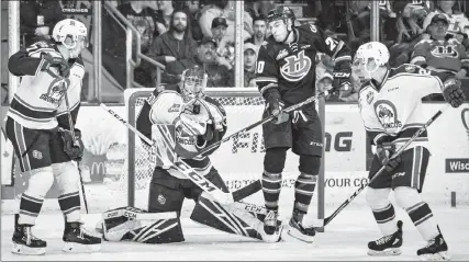  ?? Herald photo by Ian Martens ?? Lethbridge Hurricanes’ Jake Elmer flies by on a screen as Swift Current Broncos’ goaltender Joel Hofer makes a glove save between defencemen Noah King and Garrett Sambrook during Western Hockey League action Friday night at the Enmax Centre. @IMartensHe­rald