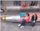  ?? NG HAN GUAN/ASSOCIATED PRESS ?? Two women sit on a bench with a U.S. flag theme in Beijing Friday. China has announced potential tariffs in retailiati­on to the Trump administra­tions’s steel tariffs.
