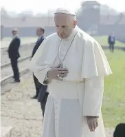  ?? THE ASSOCIATED PRESS ?? Pope Francis prays in front of a memorial at the former Nazi death camp AuschwitzB­irkenau, in Oswiecim, Poland, on Friday.