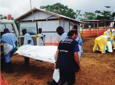  ??  ?? Volunteers carry bodies at an Ebola treatment centre run by Medecins
Sans Frontieres in Kailahun, Sierra Leone, on July 18