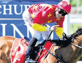  ??  ?? It’s in the bag . . . Matt Cameron gestures in glee after winning the Madison County at Riccarton Park on Saturday.