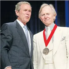  ??  ?? BADGE OF HONOUR: Former president George W Bush with Tom Wolfe during the National Endowment for the Arts National Medal Awards ceremony in Washington in 2002.
