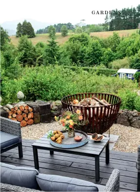  ??  ?? THIS PAGE (from top) Jason welded the oversized brazier by the deck: “You’d singe your eyebrows off if you tried to roast marshmallo­ws over it,” says Lynda. The buxus balls outside the converted stable block were lugged to the country from Lynda’s former city garden: “They’ve been in half wine barrels for over a decade but still look pretty sharp.”OPPOSITE (from top) The garden is forever expanding; this border runs down the farm race behind the stables. Summer-flowering achilleas in the picking garden.