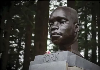  ?? MARK GRAVES/THE OREGONIAN VIA AP ?? A bust of York, a member of the Lewis and Clark expedition, is seen on Mount Tabor in southeast Portland, Ore., on Sunday. The statue appeared the day before.