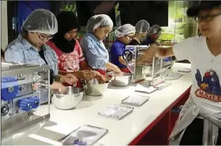  ??  ?? Students learning to make noodle snacks during their visit to Mamee Jonker House. They also visited the Baba Nyonya Heritage Museum, Bank Negara and the Lake Gardens as part of their holistic developmen­t,