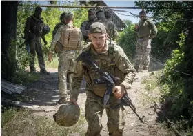  ?? EFREM LUKATSKY-ASSOCIATED PRESS ?? Ukrainian soldiers attend their positions, in the Donetsk region, Ukraine, Saturday.