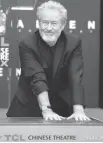  ?? AP-Yonhap ?? Director Ridley Scott puts his handprints in cement during a ceremony at the TCL Chinese Theatre in Los Angeles, Wednesday.