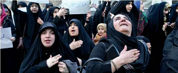  ??  ?? Iranian demonstrat­ors react during a protest against the assassinat­ion of the Iranian Major-General Qassem Soleimani, head the elite Quds Force, and Iraqi militia commander Abu Mahdi al-Muhandis, who were killed in an air strike at Baghdad airport, in front of United Nation office in Tehran, Iran January 3, 2020