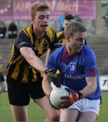  ??  ?? Páraic O’Leary of Shelmalier­s (wearing their change strip) is challenged by Dunboyne’s Jack Donnelly.