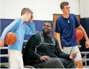  ??  ?? Auri Allen, center, coaches Will Major, left, and Luke Major at the Santa Fe Family Life Center in Oklahoma City.