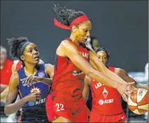  ?? Chris O’meara The Associated Press ?? A’ja Wilson (22) beats Connecticu­t Sun forward Beatrice Mompremier, left, to a rebound in the Aces’ Game 4 triumph.