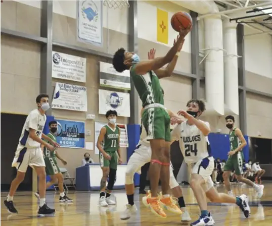  ?? ?? Moriarty's Cayden Dunn putting up a behind-the-back layup, Nov. 30, 2021. Photo by Ger Demarest.