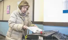  ?? ASHLEE REZIN/ SUN-TIMES ?? Jean Cali, 85, of Lincoln Park, votes Monday in the city election at the Lincoln Park Branch Library on the North Side. This municipal race has the most candidates on the ballot ever, the Board of Elections says.