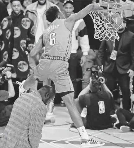  ?? GERRY BOOME / AP ?? Hamidou Diallo of the Oklahoma City Thunder leaps over 7-foot-1 Hall of Famer Shaquille O'Neal en route to winning the NBA AllStar Slam Dunk contest on Saturday in Charlotte, North Carolina.