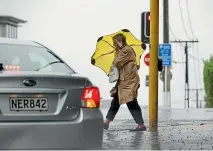  ?? DAVID WHITE/ STUFF ?? Aucklander­s battle heavy rain and strong winds.