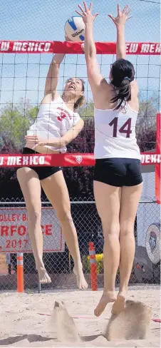  ?? MARLA BROSE/JOURNAL ?? UNM’s Ashley Kelsey (3) goes up for a spike against Colorado Mesa’s Megan Gianinetti during their beach volleyball match Saturday.