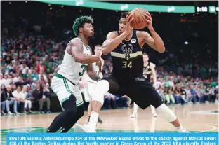  ?? —AFP ?? BOSTON: Giannis Antetokoun­mpo #34 of the Milwaukee Bucks drives to the basket against Marcus Smart #36 of the Boston Celtics during the fourth quarter in Game Seven of the 2022 NBA playoffs Eastern Conference semifinals at TD Garden on May 15, 2022.