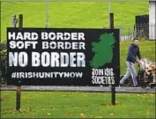  ?? Charles McQuillan Getty Images ?? A SIGN in Londonderr­y, Northern Ireland. The EU wants the British region to stay in its customs union to avoid a hard, policed land border with Ireland.