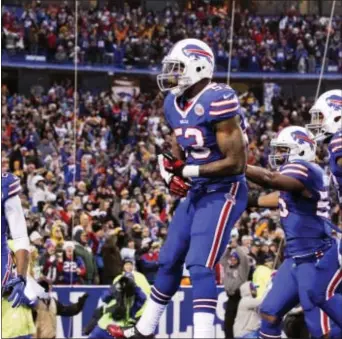  ?? THE ASSOCIATED PRESS FILE ?? Outside linebacker Nigel Bradham (center), here celebratin­g a safety with his Buffalo Bills teammates two seasons ago, was charged with assault Monday after allegedly punching a hotel worker in a dispute over an umbrella in Miami Beach.