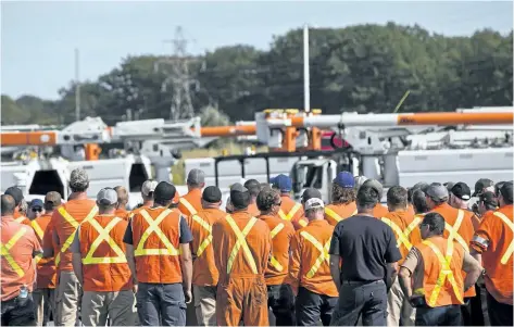  ?? THE CANADIAN PRESS ?? Hydro One workers gather at the Husky Travel Centre in Niagara-on-the-Lake Monday before starting their journey to Florida where they will help with hurricane Irma relief efforts.