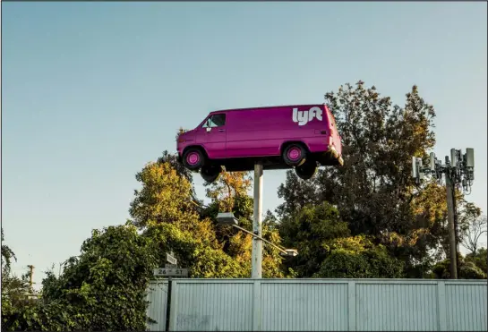  ?? CHRISTIE HEMM KLOK — THE NEW YORK TIMES ?? A van on a pole marks a driver hub for Lyft, the ride-hailing company, in San Francisco in 2017. Lyft recovered from pandemic restrictio­ns slower than Uber, and critics said it lacked the kind of ambitious investment­s that could distinguis­h itself from its rival.