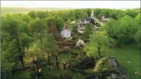  ?? JOHN WOIKE — HARTFORD COURANT VIA AP ?? This aerial view shows storm damage to Brookfield, Conn., on Tuesday. Residents in the Northeast cleaned up Wednesday, a day after powerful storms pounded the region with torrential rain and marble-sized hail, leaving more then 200,000 homes and...