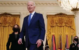  ?? Associated Press ?? ■ President Joe Biden leaves with Vice President Kamala Harris and Defense Secretary Lloyd Austin on Monday after speaking during an event to mark Internatio­nal Women’s Day in the East Room of the White House in Washington.