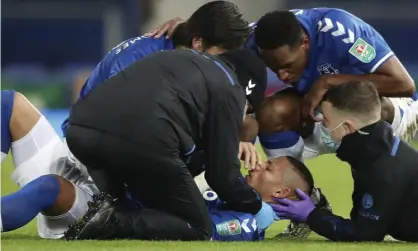  ??  ?? Everton’s Richarliso­n receives attention from medical staff after a collision with Eric Bailly during the Carabao Cup quarter-final against Manchester United. Photograph: Nick Potts/AP