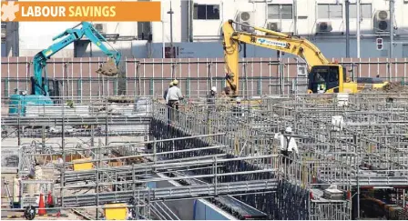  ??  ?? Power shovel machines are seen at a constructi­on site in Tokyo.
— Reuters