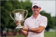  ?? JACOB KUPFERMAN — THE ASSOCIATED PRESS ?? Rory McIlroy holds the trophy after winning the Wells Fargo Championsh­ip on May 9in Charlotte, N.C.