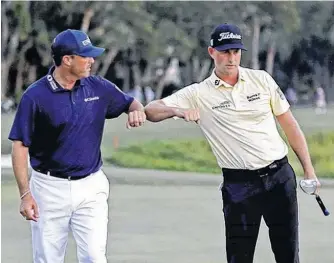  ?? USA TODAY SPORTS ?? Webb Simpson and Ryan Palmer bump elbows on the 18th green during the final round of the RBC Heritage golf tournament at Harbour Town Golf Links on Jun 21.