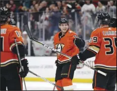  ?? Associated Press ?? CONGRATS — The Ducks’ Cam Fowler, center, celebrates his goal with Adam Henrique, left, and Sam Carrick (39) during the second period against the Vegas Golden Knights on Friday in Anaheim. The Ducks won 4-3.