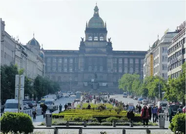  ??  ?? Tourists stroll the streets in Wenceslas Square in Prague, which funnels toward the prominent National Museum.