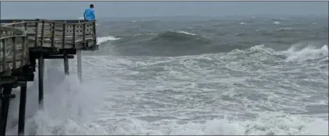  ?? GERRY BROOME — THE ASSOCIATED PRESS FILE ?? An onlooker checks out the heavy surf at the Avalon Fishing Pier in Kill Devil Hills, N.C., Thursday as Hurricane Florence approaches the east coast.