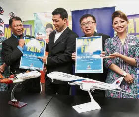  ??  ?? Options aplenty: (From left) MATTA vice-president Air Transporta­tion Shazli Affuat, Roslan and Phua holding up MATTA Fair 2018 flyers during the announceme­nt of MAS as the official airline for the event. By AMANDA LESSLER