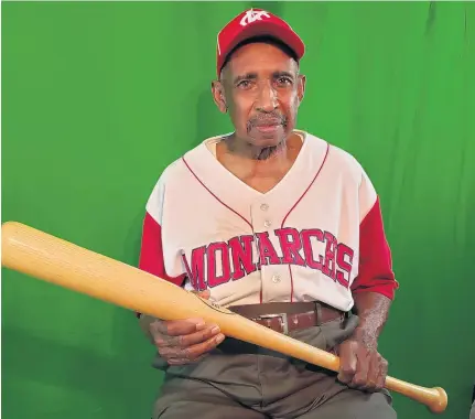  ?? LARRY RUBAMA/STAFF PHOTOS ?? Norfolk’s Sam Allen, 84, dons a jersey and cap of the Kansas City Monarchs, one of the three Negro Leagues teams he played for in the 1950s.