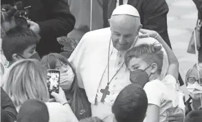  ?? GREGORIO BORGIA/AP ?? Pope Francis meets with children in the Paul VI Hall on Sunday at the Vatican. Francis has denounced domestic violence against woman as “nearly satanic” and said parents should never slap their children.