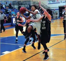  ?? FRANK CROWE / For the Calhoun Times ?? Gordon Central’s Mercedes Coleman (23) goes up for a shot over Pepperell’s Kaylee Mansell during the first half on Tuesday.