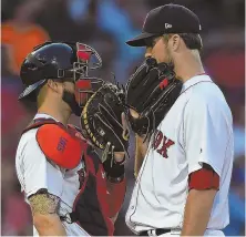  ?? STAFF PHOTOS BY CHRISTOPHE­R EVANS ?? LOSING CAUSE: Starter Drew Pomeranz (above right) chats with catcher Blake Swihart in the second inning, and Xander Bogaerts (below) is hit on the hand with a pitch in the ninth inning of the Red Sox’ 3-1 loss to the Philadelph­ia Phillies last night at...