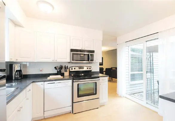  ??  ?? The townhouse at 6076 West Greenside Dr. in Cloverdale sold for $315,000 in late June, thanks in part to its abundant natural light and extensive green space.