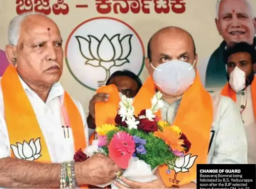  ??  ?? CHANGE OF GUARD Basavaraj Bommai being felicitate­d by B.S. Yediyurapp­a soon after the BJP selected him as Karnataka CM, July 27