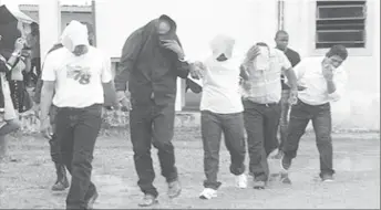  ??  ?? From left in handcuffs are Doodnauth Chattergoo­n, Rajendra Persaud, Khemraj Lall, Marlon Lawrence and Cleve Thornhill after they appeared in court on June 12