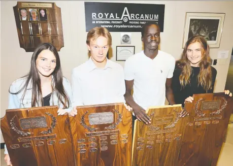  ?? NICK BRANCACCIO ?? Royal Arcanum recipients Kim Orton of Essex, left, Spencer Campeau of Essex, Akot Aken of Kennedy and Alessandra Pontoni of Sandwich receive their awards Friday at the Windsor Sportsmen’s Club.