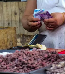  ?? PHOTOGRAPH BY YUMMIE DINGDING FOR THE DAILY TRIBUNE ?? FOOD prices are expected to soar following the continued rise in inflation. Above, a market vendor in Quezon City counts the day’s earnings on Sunday.