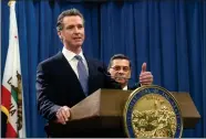  ?? AP PHOTO BY RICH PEDRONCELL­I ?? California Gov. Gavin Newsom answers a question concerning a lawsuit the state will likely file against President Donald Trump Friday, Feb. 15, in Sacramento, Calif.